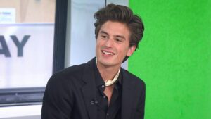 Peter Dager holding a Dota 2 trophy, symbolizing esports leadership and strategic skill