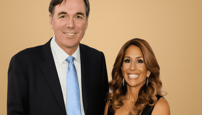 Tara Beane standing with Billy Beane at an Oakland Athletics game