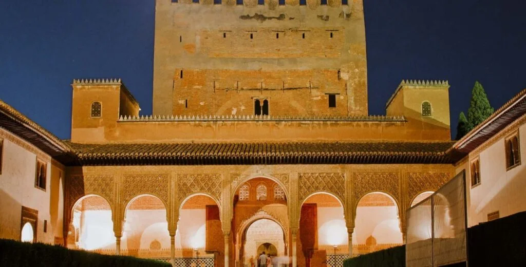Alhambra Palace night tour attendance revenue, illuminated Nasrid Palaces, evening visitors enjoying the heritage site